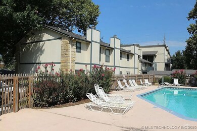 Community pool with fence and a patio
