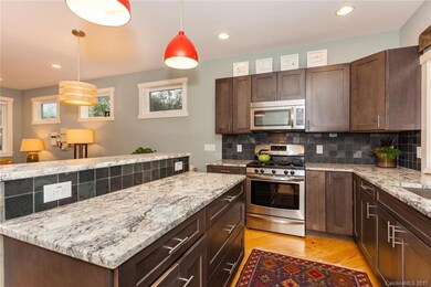 Kitchen Island with Bar Top and Tile Backsplash