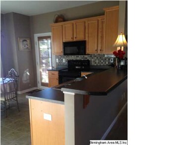 Eat-in kitchen with access to patio and open to gr