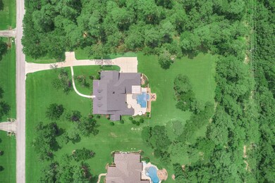 Located on a beautifully landscaped lot the home has lots of privacy and shows impeccably inside and out. The home had a new roof added in 2020, new negative edge pool added 2019 and shows like a new construction home. Simply gorgeous!