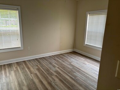 Spare room featuring wood finished floors