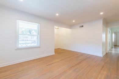 Empty room featuring ornamental molding and light 