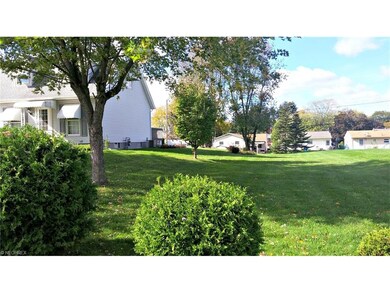 The lot is adjacent and to the rear-very nice! It 