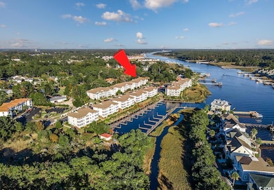 Aerial view of property and surrounding area featuring a large body of water