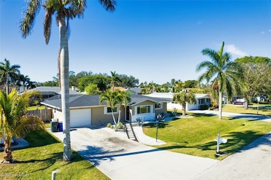 Single story home featuring a garage and a front y