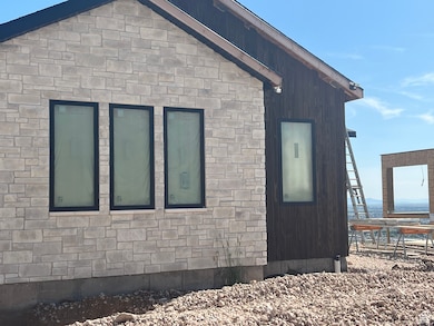 View of side of home with stone siding