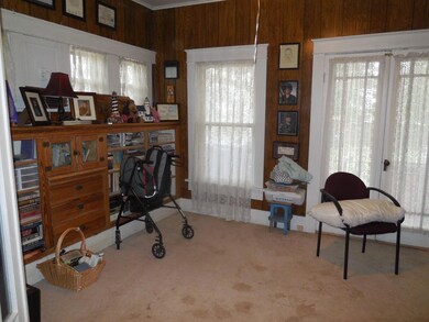 Home office featuring wood walls and carpet floors