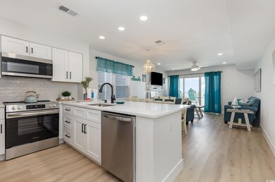 Kitchen featuring a peninsula, visible vents, rece