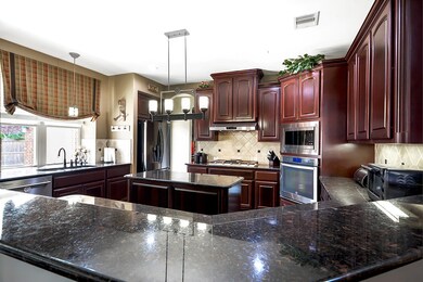 Breakfast Bar seating and storage cabinets on kitchen island with electrical outlets.