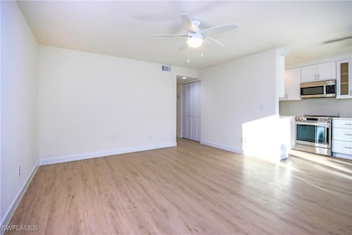 Unfurnished living room featuring light wood-style