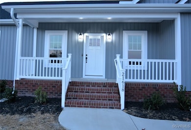 View of exterior entry with covered porch
