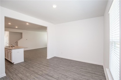 Empty room with recessed lighting and wood finished floors