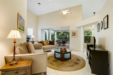 Living area featuring high vaulted ceiling, tile f