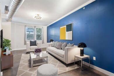 Living room with concrete floors, ornamental moldi