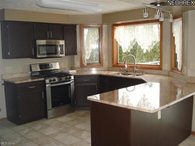 Updated kitchen with ceramic tile floor and granit