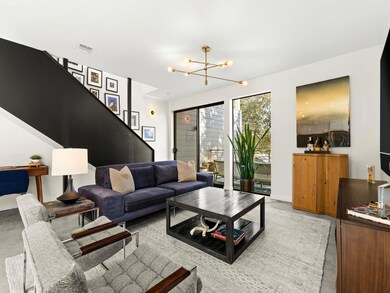 Living area featuring stairway and a chandelier