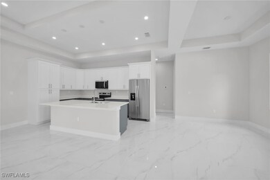 Kitchen featuring baseboards, recessed lighting, w