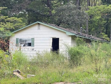 Side view of 3 BR/2 BA House on front of property built in 1979 but needs a full remodel of a tear down. 