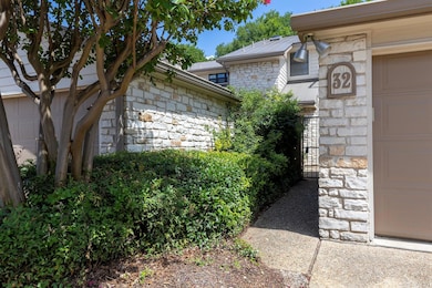 View of property exterior with stone siding