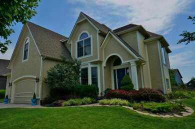 Beautiful landscaping surrounds the home.
