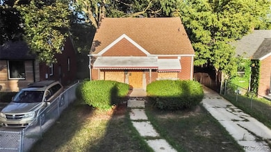 View of front of property featuring a shingled roof and brick siding