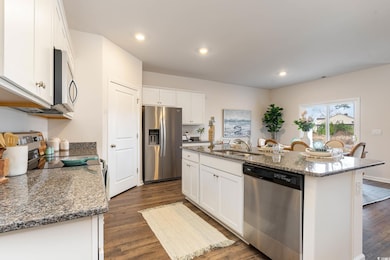 Kitchen with a sink, dark wood finished floors, ap