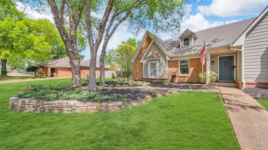 View of front of property with brick siding and a 
