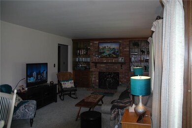 Living room area with wood burning fireplace and b
