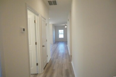 Hall with light hardwood / wood-style floors
