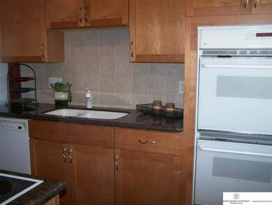 Newer cabinets, granite countertops, newer appliances include double ovens, 5 burner stove top, microwave, dishwasher, disposal, and refrigerator.