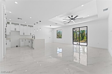 Unfurnished living room with a tray ceiling, ceili