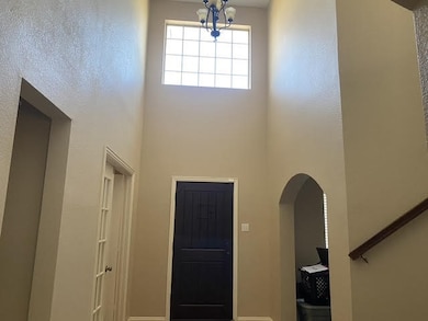 Foyer with a chandelier and a high ceiling
