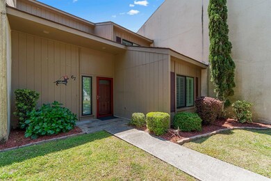 View of exterior entry with a lawn
