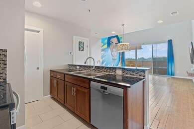 Kitchen featuring a sink, baseboards, dark counte