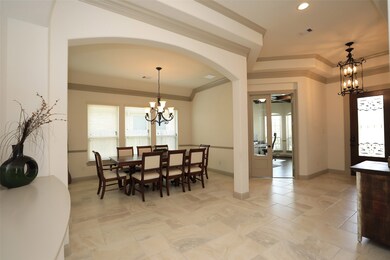 FORMAL DINING ROOM:  A wall of windows provide filtered natural light in this pretty space that is perfect for entertaining friends, celebrating holidays or enjoying family celebrations.