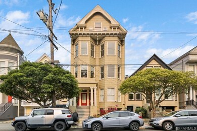 Grand facade on a tree-lined Cole Valley street.