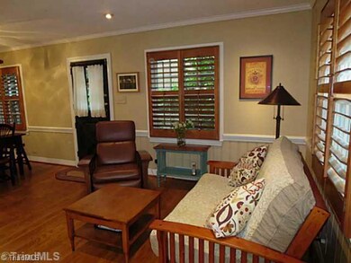 Den/Family/Great Room. Den with Wood Floors, Plantation Shutters, Fireplace, and Wainscoating