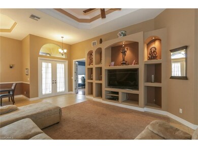 The cozy den located just off the entry makes a perfect home office and boasts hard wood floors and French doors for privacy.