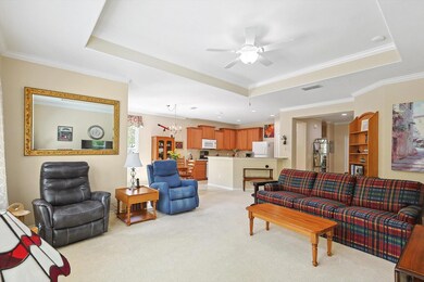 Living room featuring ceiling fan with notable cha