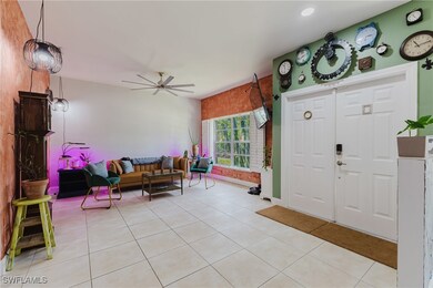 Entryway with ceiling fan and light tile patterned