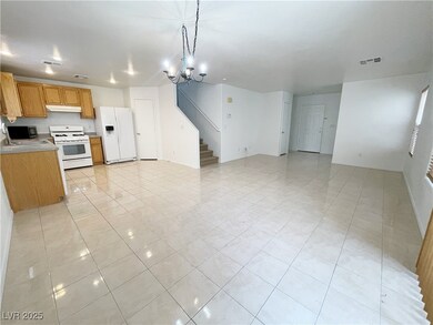 Kitchen with white appliances, visible vents, unde
