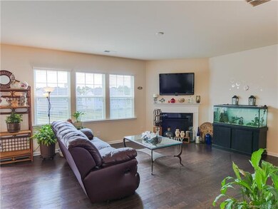 Large living room with vented gas log fireplace.