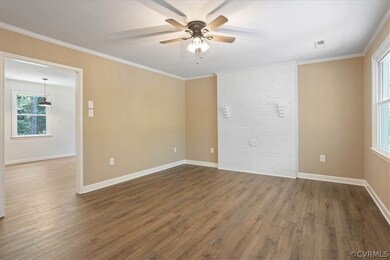 Unfurnished room with crown molding, brick wall, c