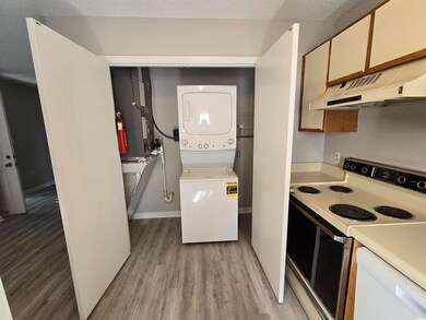 Kitchen with light wood-type flooring, a textured 