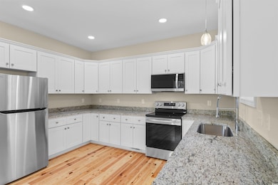 Kitchen featuring stainless steel appliances, ligh