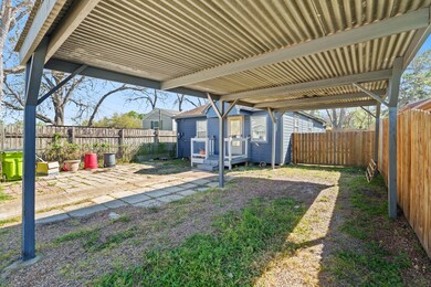 Expansive carport provides ample cover for vehicle