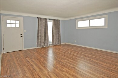 living room with front door and wood styled flooring