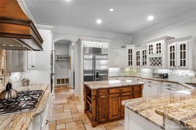 The gourmet kitchen glass front cabinetry painted 