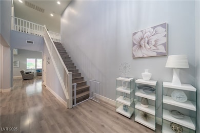 Volume ceilings with dramatic staircase at entry.
