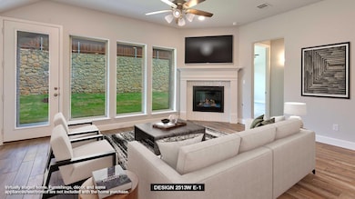 Living area featuring a ceiling fan, wood finishe